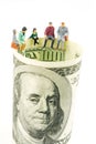 miniature figurines discussion on the edge of 100 dollar banknote Royalty Free Stock Photo