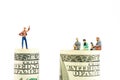 Miniature figurines discussion on the edge of 100 dollar banknote Royalty Free Stock Photo