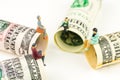 Miniature figurines discussion on the edge of 100 dollar banknote Royalty Free Stock Photo