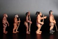 miniature figurines of prehistoric men on line - human evolution concept Royalty Free Stock Photo