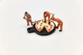 miniature figurines of a team of workers with a huge pizza