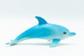 Miniature and game for children of a white and light blue dolphin on a white background. Royalty Free Stock Photo