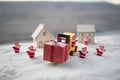 Miniature Gift Box by Forklift Machine on snow ,Determined Image for Christmas Holiday and Happy New Year Gift Celebration concept