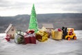 Miniature Gift Box by Forklift Machine on snow ,Determined Image for Christmas Holiday and Happy New Year Gift Celebration concept