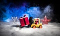 Miniature Gift Box by Forklift Machine on snow ,Determined Image for Christmas Holiday and Happy New Year Gift Celebration concept