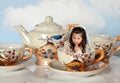 Miniature girl on tea party