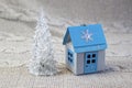 Miniature glas christmas tree and winter house made of paper  handmade  close-up on a light background Royalty Free Stock Photo