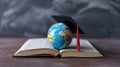Miniature globe with a graduation cap on top, placed on an open book.. AI generated Royalty Free Stock Photo