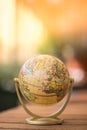 Miniature globe model on a rustic wooden table. Symbol for travelling Royalty Free Stock Photo