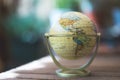 Miniature globe model on a rustic wooden table. Symbol for travelling Royalty Free Stock Photo