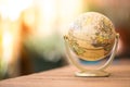 Miniature globe model on a rustic wooden table. Symbol for travelling