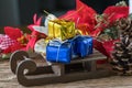 miniature golden and blue present gift boxes on Santa claus sleigh as christmas eve celebration concept Royalty Free Stock Photo