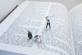 Miniature Golfers Playing on an Open Book Page in Creative Concept Royalty Free Stock Photo