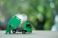 Miniature green plastic garbage truck. Children toy