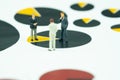 Miniature businessman meeting and standing on pie chart