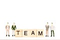 Miniature group businessman standing with Words of business Team concepts collected in crossword Royalty Free Stock Photo