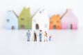 Miniature group of different kind of people over blurred house