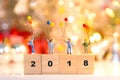 Miniature group happy family holding balloons standing on wooden 2018 with party happy new year, Royalty Free Stock Photo