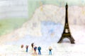 Miniature Group hiker and traveler backpack standing on wold map for travel Eiffel Tower in France and around the world, Royalty Free Stock Photo