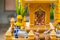 Miniature guardian spirit house. Small buddhist temple shrine, colorful flower garlands. San phra phum erected to bring fortune.