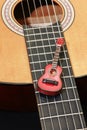 Miniature guitar on acoustic guitar