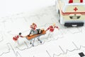Miniature health care team transport patient to ambulance car