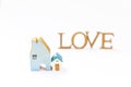 Miniature house with blurred love background, new house