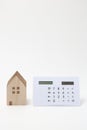 Miniature house and calculator.