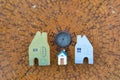 Miniature house design on ancient wooden feng shui compass background