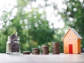 Miniature house, Glass bottle and stack of coins. The concept of saving money for house, Property investment, House mortgage, Real Royalty Free Stock Photo