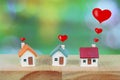 Miniature house with heart sign and blur light bokeh ,love family