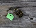 Miniature house key holder with key and lock on vintage wooden planks in close up layout Royalty Free Stock Photo
