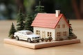 Miniature house and keys on table representing real estate purchase and home ownership concept