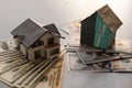 Miniature house model with banknotes on a wooden table, selective focus. Home loan concept. Royalty Free Stock Photo