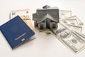 Miniature house model with banknotes on a wooden table, selective focus. Home loan concept. Royalty Free Stock Photo