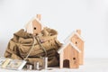 Miniature house model in the brown color Backpack and beside have dollar bills, money coins on white background Royalty Free Stock Photo