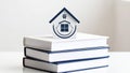 Miniature house model on stack of books, concept of real estate education Royalty Free Stock Photo