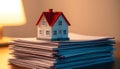 Miniature House Model on Stack of Documents Royalty Free Stock Photo