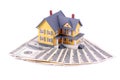 Miniature house over money isolated