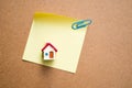 Miniature house on paper note using as business concept Royalty Free Stock Photo