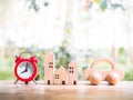 Miniature house, Red alarm and wooden toy car. Concept of saving money for buy a house and car Royalty Free Stock Photo