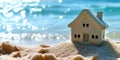 A miniature house on the sand against the backdrop of the sea or ocean. Travel vacation rental concept. Resort property