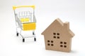 Shopping cart and house on white background. Concept of buying new house, real estate and home mortgage. Royalty Free Stock Photo
