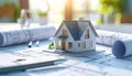 Architectural Model of a House on Blueprints with Rolled Plans and Tools house model Royalty Free Stock Photo