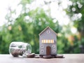 Miniature house on stack of coins. The concept of saving money for house, Property investment, House mortgage, Real estste Royalty Free Stock Photo