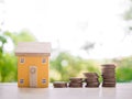 Miniature house and stack of coins. The concept of saving money for house, Property investment, House mortgage, Real estste Royalty Free Stock Photo