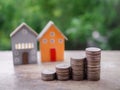 Miniature house and stack of coins. The concept of saving money for house, Property investment, House mortgage, Real estste Royalty Free Stock Photo