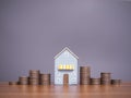 Miniature house and stack of coins. The concept of saving money for house, Property investment, House mortgage, Real estste Royalty Free Stock Photo