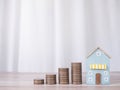 Miniature house and stack of coins. The concept of saving money for house, Property investment, House mortgage, Real estste Royalty Free Stock Photo