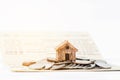 Miniature house stand on the stack of coins on book bank. Royalty Free Stock Photo